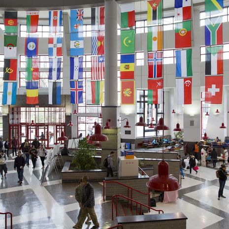 International flags hanging from ceiling in student center lobby at Temple