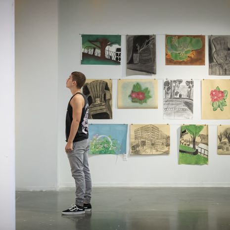 Student standing in a art gallery.