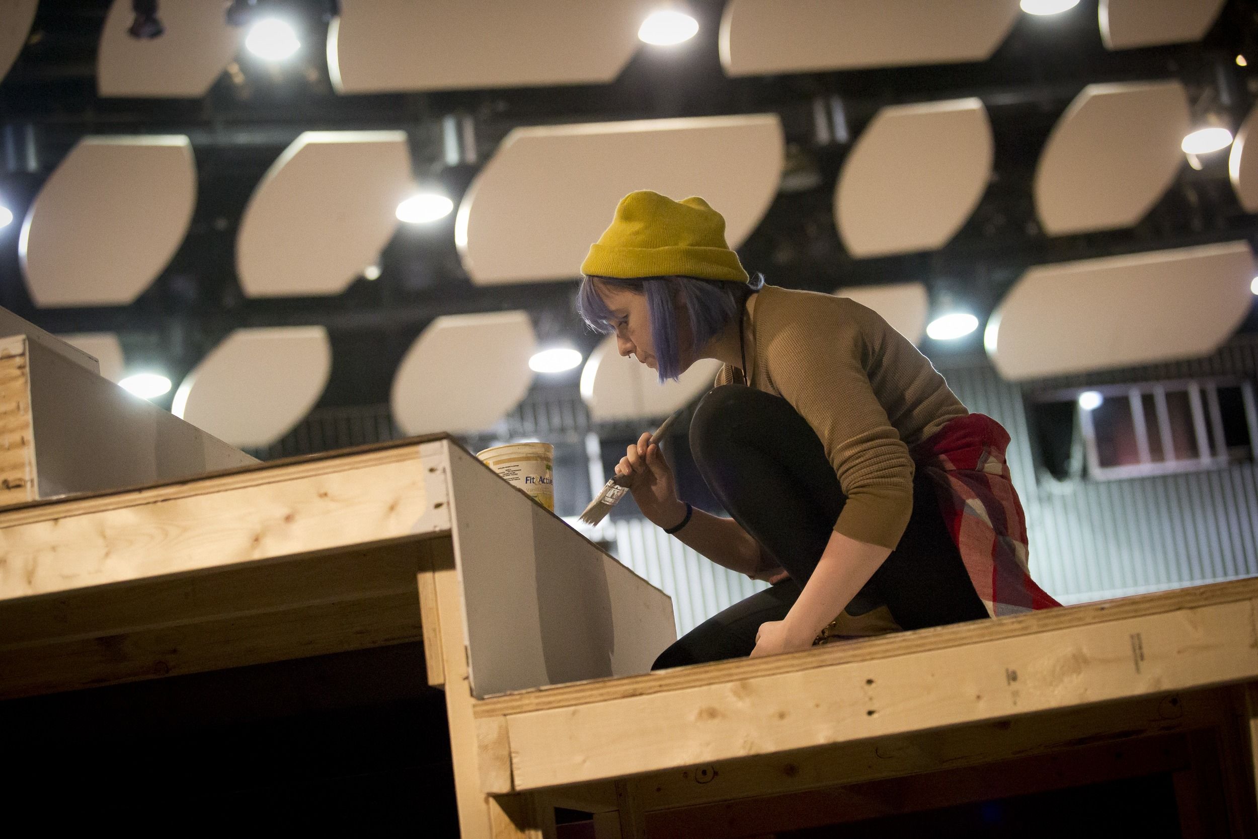 A theater student helps prepare a set.