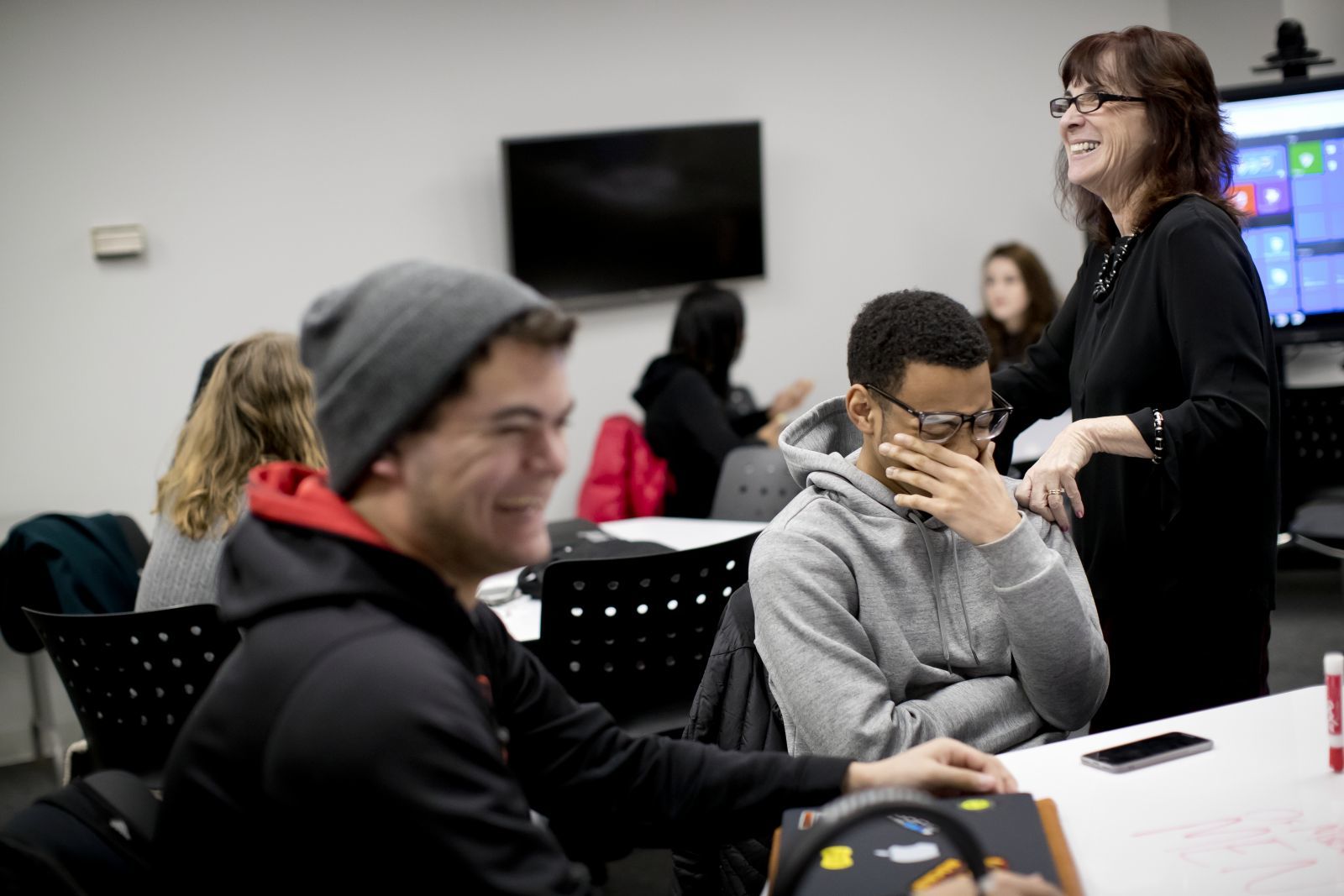 Students in a classroom laughing.