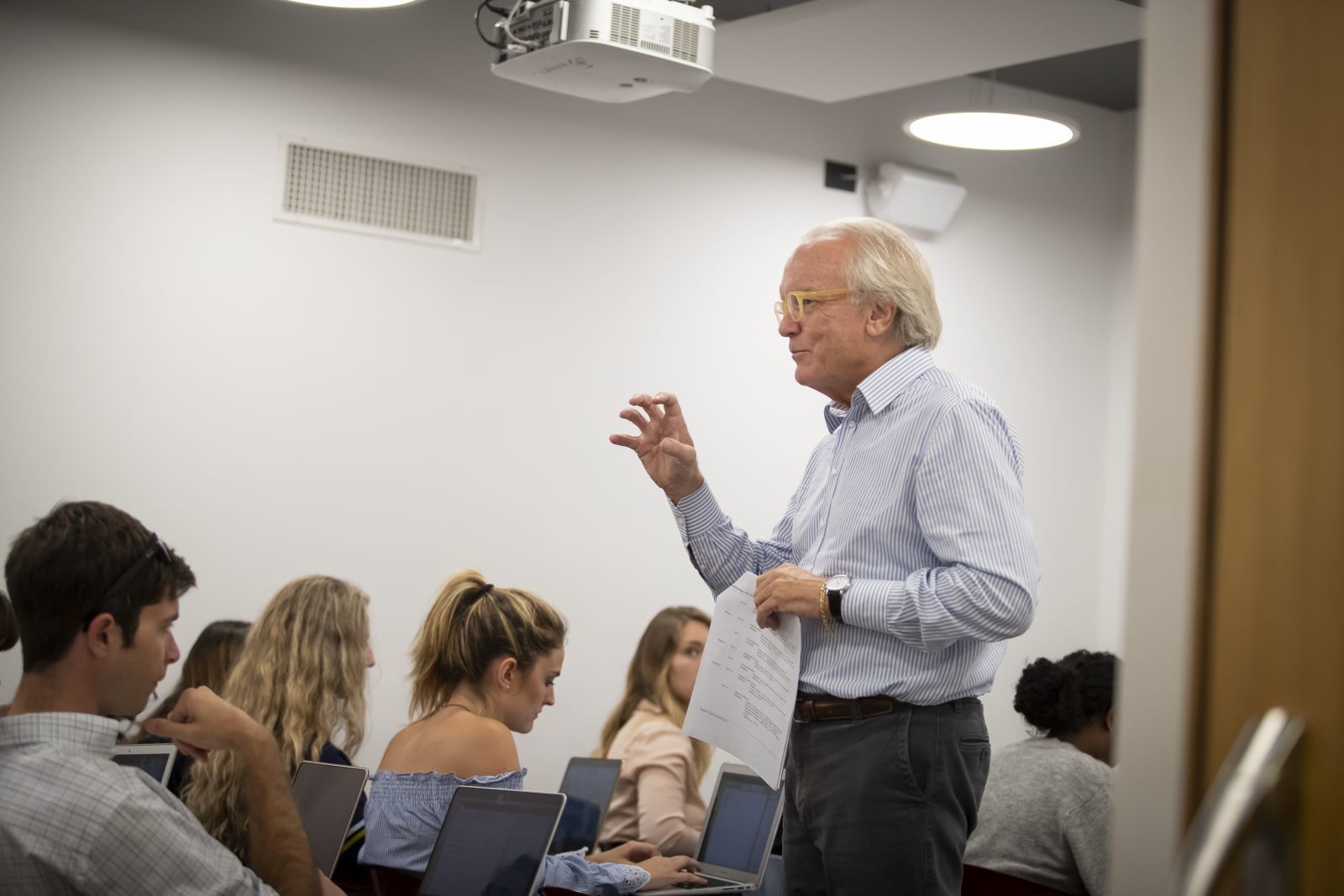 A professor lecturing in a classroom.