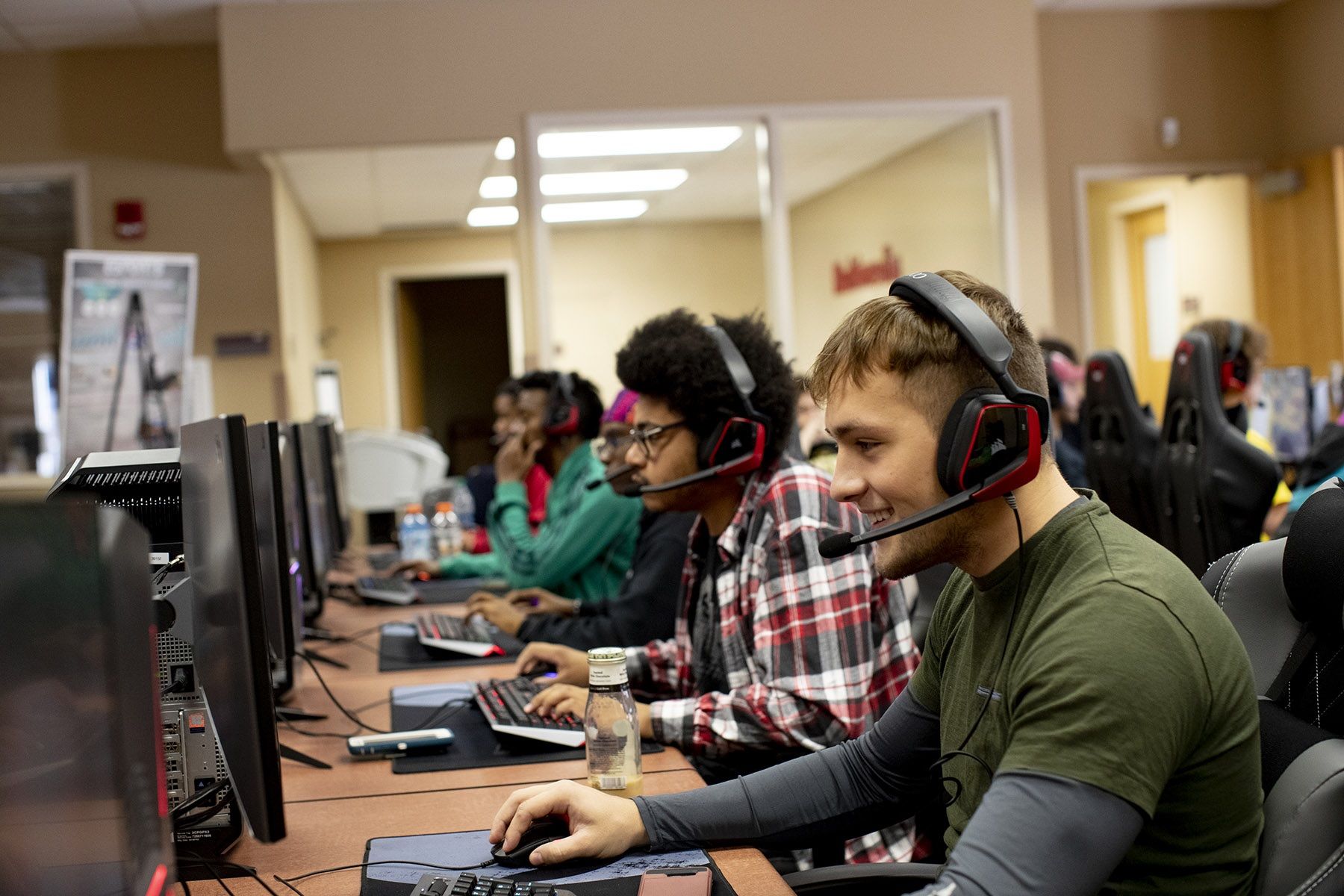 Rows of students wearing headphones in a computer lab