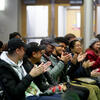 Attendees clapping during a presentation
