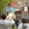 Students walking on campus with band playing