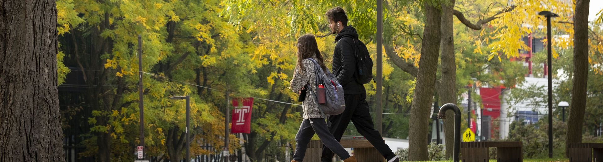 Students walking on Temple's campus in the fall. 