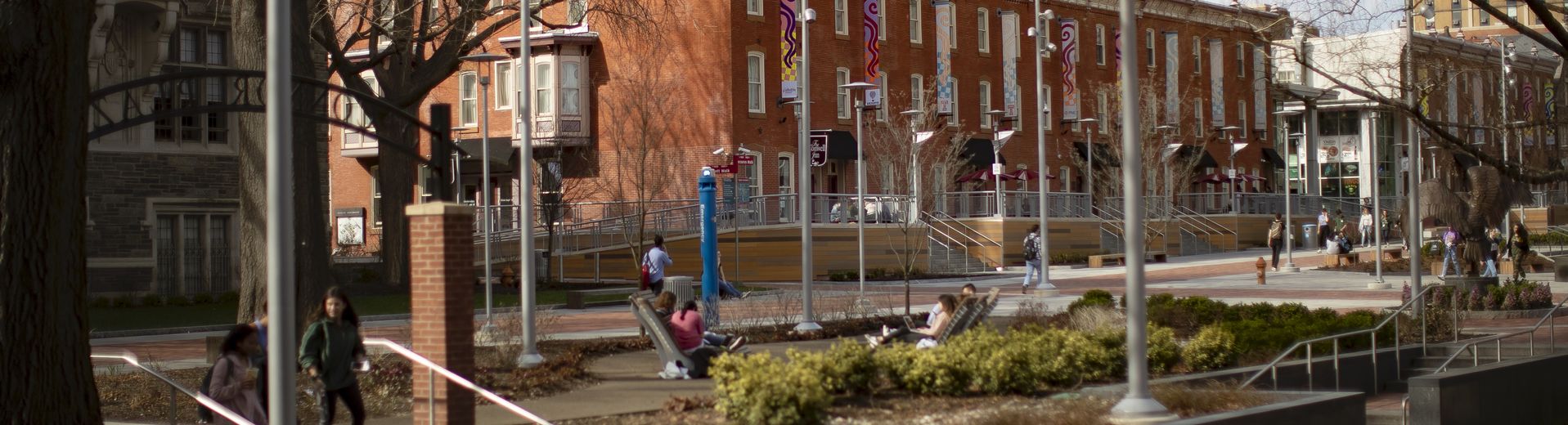 Early spring campus image with students walking down Liacouras walk